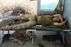  Nap time… A tired female British soldier asleep on her cot, her SA80 rifle at her feet. Nice ink from what can be seen.   Some of the best sleep I&rsquo;ve ever had looked like this