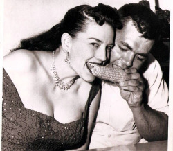  Evelyn West   aka. “The โ,000 Treasure Chest”.. Seen here in a 50’s-era UPI press photo, sharing corn-on-the-cob with lucky fratboy: Whitney O’Keefe.. The popular stripper generated considerable free publicity for her local theatre appearances,