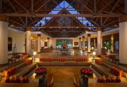 theleela:  A blend of tan gold, khaki, cream and sepia tones accentuated by white Italian lamps and mother-of-pearl table decorations, the grand lobby at The Leela Kovalam is a place where architecture meets art in style. The high beamed ceiling with