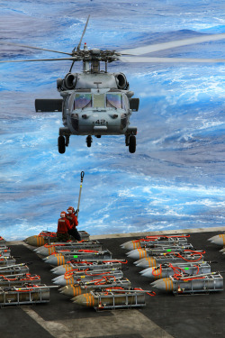 fuckyeahusnavy:  An MH-60S Sea Hawk helicopter assigned to the Dragon Whales of Helicopter Sea Combat Squadron (HSC) 28 picks up ammunition from the aircraft carrier USS Enterprise (CVN 65) during the carrier’s last ammunition offload. Enterprise is
