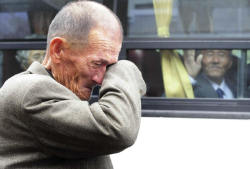 historicallysound:  A North Korean man waves his hand as a South Korean relative weeps, following a luncheon meeting during inter-Korean temporary family reunions at Mount Kumgang resort October 31, 2010. Four hundred and thirty-six South Koreans were