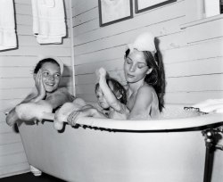 tigereef:     This is an early photo of Kate Moss and her friend and her friend’s daughter taking a bath. It is beautiful, so I am printing it out on the good picture paper and putting it on my wall until they make me take it down for being inappropriate