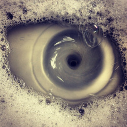 asksecularwitch:  sonneillonv:  awesomephilia:  “Tried taking a picture of a sink draining, wound up with a picture of an eye instead.” (via)  For a second there, I was seriously rapid-blinking in sympathy with whoever had that much soap in their