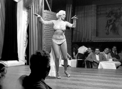   Mae Blondell     aka. “The Statuesque Blonde”.. Dancing on stage for patrons at a Chicago nightclub, sometime in 1952..  