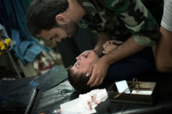 alibaadi:  Wounded by Syrian Army shelling, a child is comforted by a Free Syrian Army fighter 