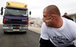 Can you hear me now? (Lasha Pataraia of Russia pulls an 8-ton truck lashed to his ear)