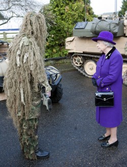 wired:  journalofajournalist:  Queen Elizabeth visited a military base and a million memes bloomed. (via Photo of the Day: Nov. 26, 2012)  Absolutely no explanation necessary. Right-o!  If I were royalty, I wouldn&rsquo;t be that close to a cloaked person