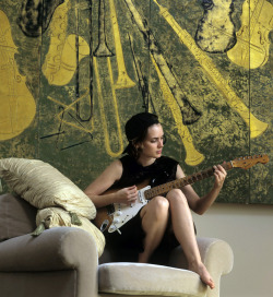  Winona Ryder playing guitar in her apartment by Joe McNally, 1994 